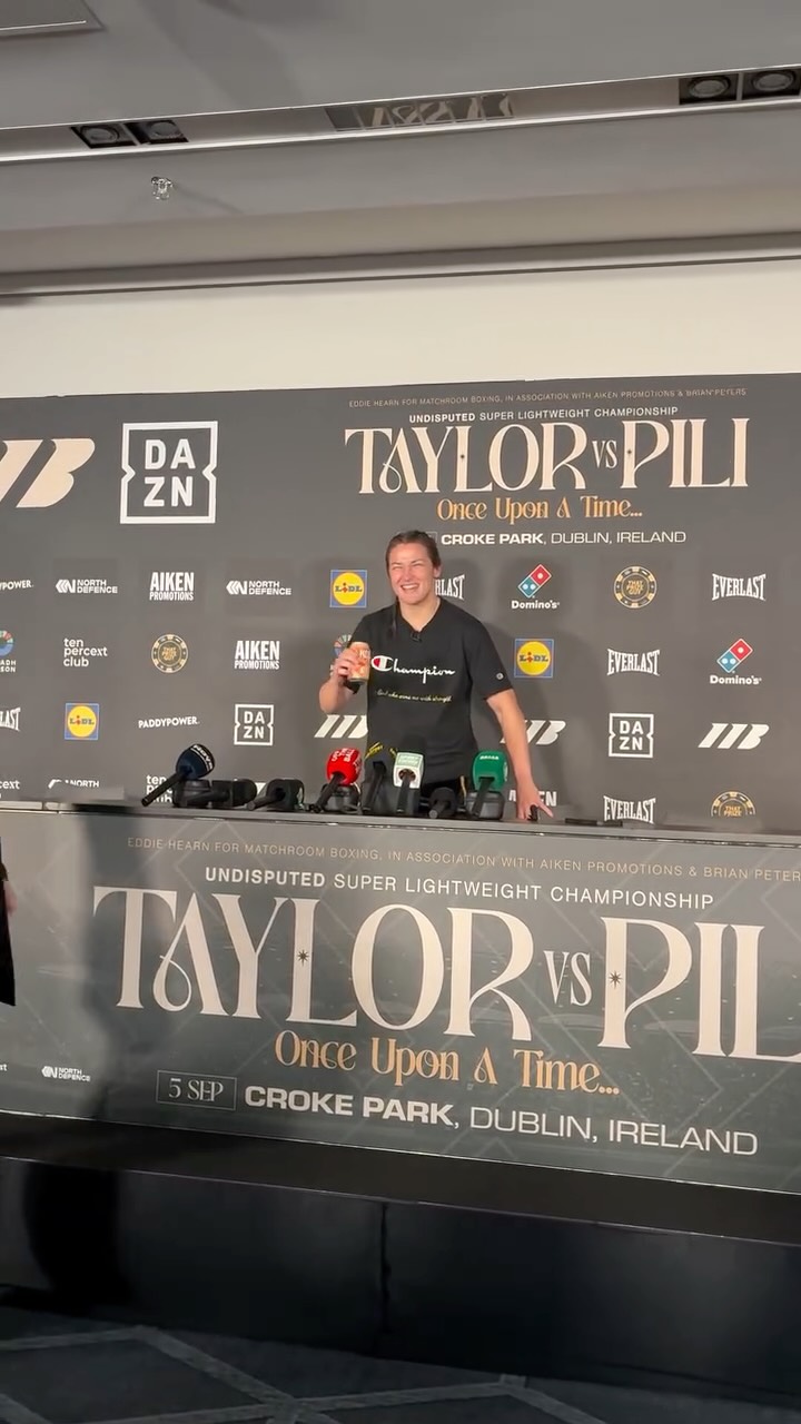 @katie_t86 arrives at the press conference post fight with her @fizzique_drinks in hand